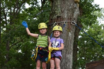 2 young children enjoying the Soaring Six kid-friendly zipline